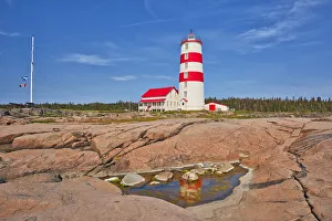 Prints of Canada, Quebec, Pointe-des-Monts. Lighthouse on shore of St. Lawrence River. Credit as: Mike Grandmaison / Jaynes Gallery / DanitaDelimont.com Images Dated 2020 March: Canada, Quebec, Pointe-des-Monts. Lighthouse on shore of St. Lawrence River
