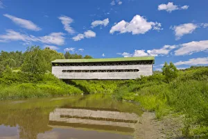 Canada, Quebec, St-Bruno-de-Guigues. Covered bridge over river