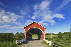 Canada, Quebec, Ste. Jeanne d Arc. Covered bridge over stream