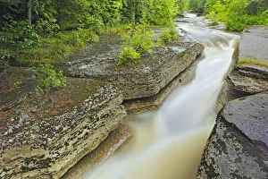 Canada, Quebec, Val-Jalbert. River Ouiatchouan flows between rocks