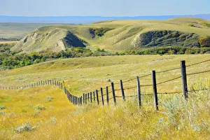 Canada, Saskatchewan, Maple Creek. Fence and prairie landscape