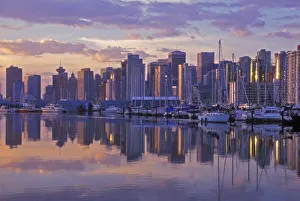 Canada, Vancouver, British Columbia. Vancouver Skyline with boats in harbor at sunrise