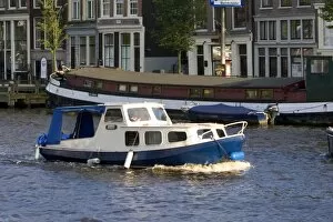 Canal boat on the Amstel River in Amsterdam, Netherlands