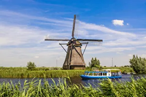 Windmill Prints: Canal tour boat and windmill in Unesco World Heritage Site, Kinderdijk, Holland