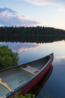 Images Dated 28th June 2012: A canoe on Little Berry Pond in Maines Northern Forest. Sunset. Cold Stream watershed