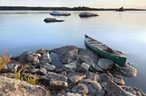 Images Dated 15th August 2006: Canoe at sunset from rock island off the shore of Round Bear Island, Kabetogama Lake
