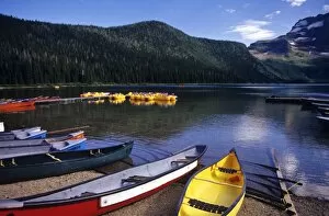 Canoes and pedal watercraft await tourists at Cameron lake in Waterton Lakes National