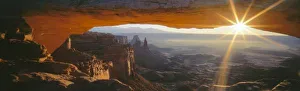 CANYONLANDS NATIONAL PARK, UTAH. USA. View through Mesa Arch at sunrise. Island in the Sky
