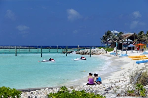 Images Dated 25th March 2012: Caribbean, Bahamas, Castaway Cay. Women on beach at Castaway Cay