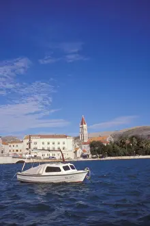 Water Way Prints: The Cathedral of Saint Lovro in Trogir stands behind a small boat in the Trogir Canal