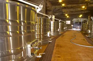 Industry Prints: Cellar in an old stone quarry, modern stainless steel fermentation vats. Chateau Belair