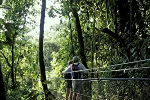 Images Dated 13th April 2004: Central America, Costa Rica, Monteverde Cloud Forest Hikers on suspension bridge