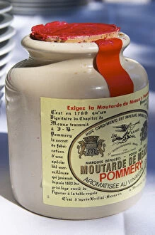 A ceramic French mustard pot with a red lid - Chateau Pey la Tour, previously Clos