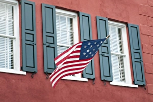 Images Dated 8th April 2010: Charleston, South Carolina, USA. An Amerian flag flies over windows on a colorful