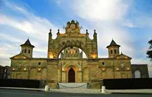 Gironde Prints: Chateau Cos d Estournel, the gate and the facade at dusk with flood lights floodlit blue sky