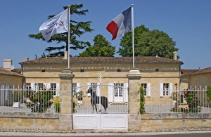 Opening Prints: Chateau La Couspaude, the main building, with a white iron fence a French flag