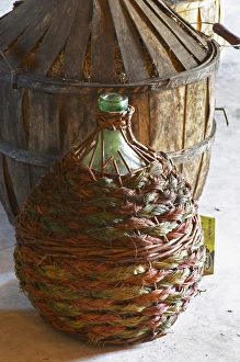 Storage Prints: Chateau Rives-Blanques. Limoux. Languedoc. Demijohns with wine in wicker baskets