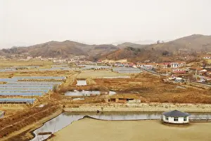 Great Wall Prints: China, Dandong, elevated view of a salt pond with human settlement and mountains