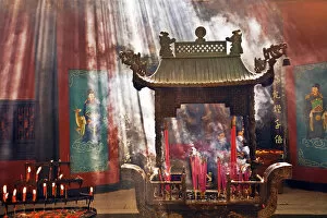 Images Dated 22nd September 2007: China, Hangzhou, Lingyin Buddhist Temple candles and incense burn at an alter as buddists pray