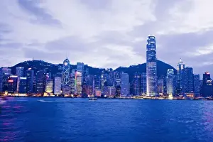 Victoria Harbour Prints: China, Hong Kong, Early evening view of the city as seen by boat from Hong Kong Harbor