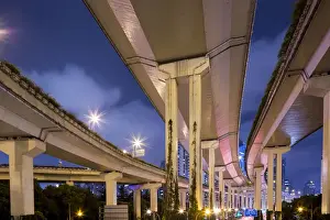 Infrastructure Prints: China, Shanghai, Towering overpass of Yanaaan Expressway with city skyline in distance