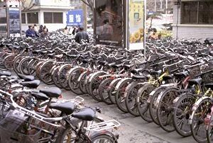Sichuan Province Gallery: China, Sichuan Province. Mass of bicycles parked on sidewalk-Chengdu