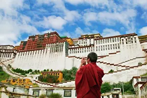 Tibetan Prints: China, Tibet, Lhasa, Tibetan monk with Potala Palace (MR)