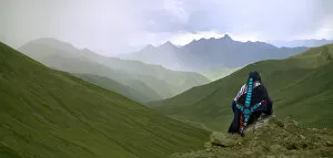 China, Tibet, Tibetan woman with the Himalayas