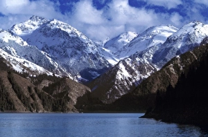 Tien Shan Prints: China, Xinjiang, Heavenly Lake. Heavenly Lake reflects a blue sky and is surrounded