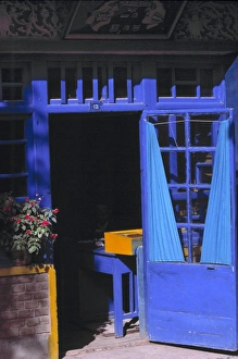 Complimentary Color Prints: China, Xinjiang, Kashgar. Behind an open, periwinkle blue-painted door with blue curtains