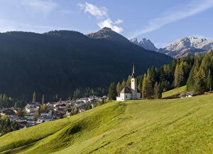 Cityscapes Collection: The church, in the background Focobon mountain range in the Pale di San Martino