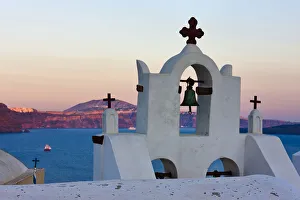 Church bell tower on the coast of Aegean Sea. Oia, Santorini Island, Greece