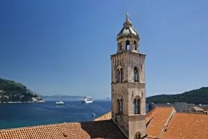 Church bell tower and cruise ship docked in the Adriatic Sea at historic Dubrovnik