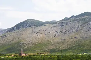 Bucolic Prints: A church on the plain dominated by the Kastrat Shkrel mountains near Koplik