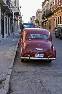 Images Dated 20th August 2005: A classic old red Peugeot car parked on a street corner, probably from the 1950s