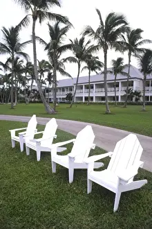 Expensive Prints: Classic white Adirondack chairs at the Elegant Ocean Club in Paradise Islands Bahamas
