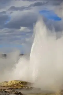 Boiling Prints: Clepsydra Geyser erupts in late afternoon light in the Lower Geyser Basin of Yellowstone
