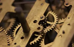 Images Dated 2032: Close Up abstract of internal moving parts of an old watch with brass wheels of an