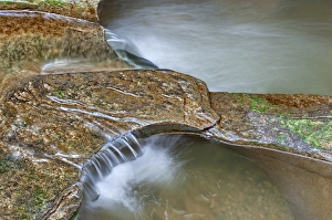 Opening Prints: Close-up of potholes - large, circular openings in the sandrock canyon bed - at Fall Creek Gorge