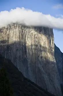 Jim Goldstein Prints: A cloud forms atop El Capitan shrouding the top of the cliff-face - Yosemite National Park