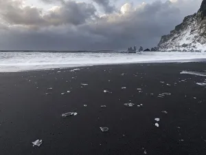 Coast near Vik i Myrdal during winter. Black volcanic beach with the Reynisdrangar sea stacks