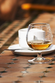Coffee and a snifter glass with golden Vieux Marc de Chateauneuf, made from chateaunef Coffee and a snifter glass with golden Vieux Marc de Chateauneuf, made from chateaunef