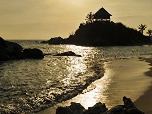 Images Dated 11th April 2012: Colombia, Tayrona National Park, Cabo San Juan de la Gua. Sunrise silhouette