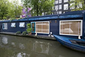 Images Dated 6th September 2007: a colorful blue houseboat with matching row boat on a canal