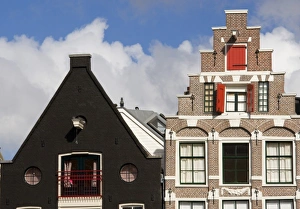 Colorful buildings with ornate facades and windows with red shutters against a blue Colorful buildings with ornate facades and windows with red shutters against a blue
