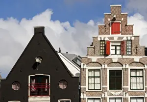 Fluffy Prints: Colorful buildings with ornate facades and windows with red shutters against a blue