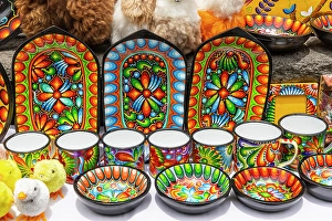 Pottery Prints: Colorful dishes, and stuffed ducks were on sale on the walls of the Basilica of Quito