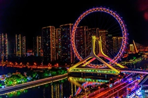 Prints of Colorful large ferris wheel over Yongle Bridge, Tianjin, China. Built in 2007 Images Dated 2024 December: Colorful large ferris wheel over Yongle Bridge, Tianjin, China. Built in 2007