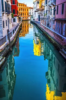 Venice Prints: Colorful small canal creating beautiful reflection in Venice, Italy