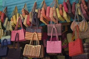 Colorful straw bags on display in market, Lima, Peru